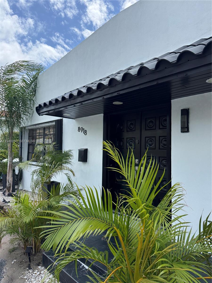 a view of front door and potted plants