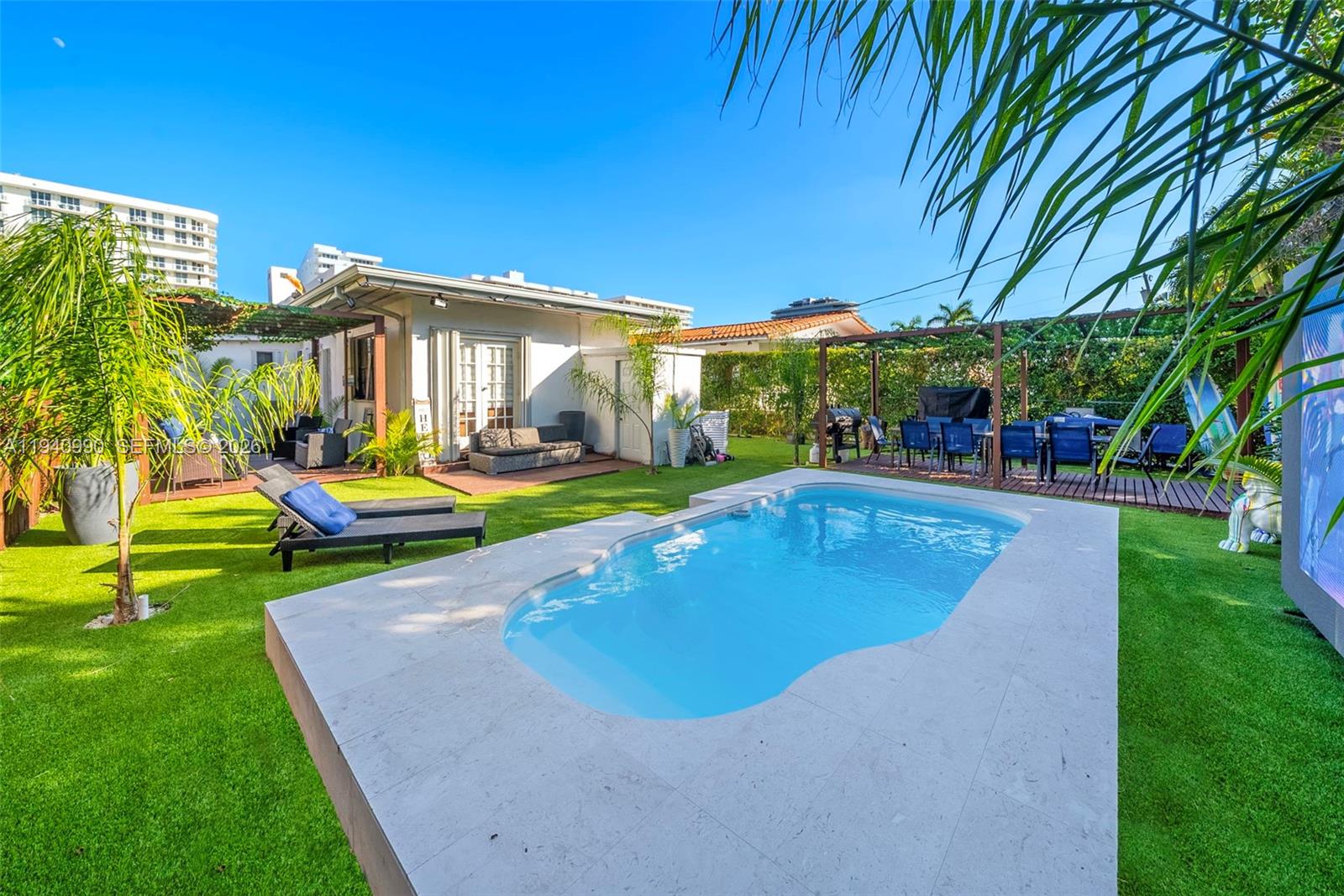8918 Harding Avenue Surfside, FL 33154 - Photo 6 of 24 a view of a house with a backyard porch and sitting area