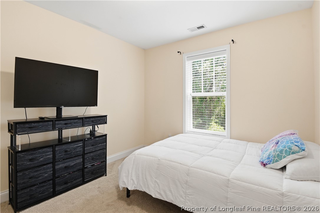 140 Birch Avenue Spring Lake, NC 28390 - Photo 37 of 49 a bedroom with a bed and a flat screen tv