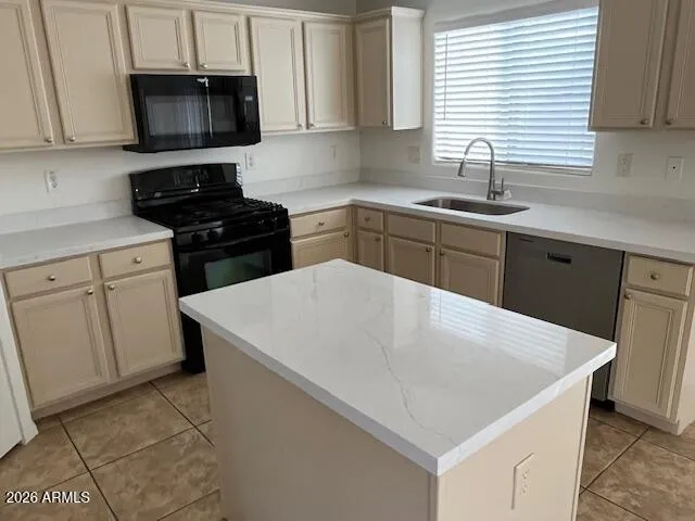 a kitchen with a sink a stove and cabinets