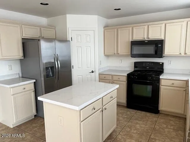 a kitchen with a stove a refrigerator and a sink