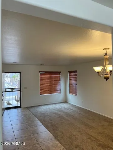 an empty room with windows and fireplace