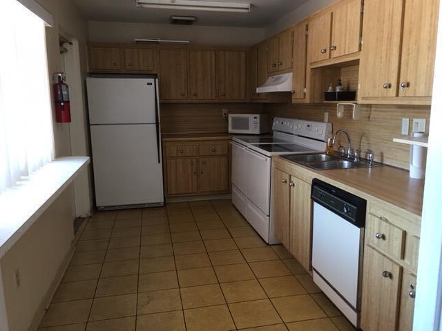 4154 Inverrary Drive, Unit 407 Lauderhill, FL 33319 - Photo 30 of 39 a kitchen with a refrigerator sink and cabinets