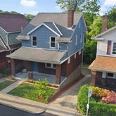 a aerial view of a house next to a yard