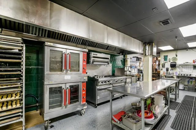 a open kitchen with stainless steel appliances granite countertop a stove and cabinets