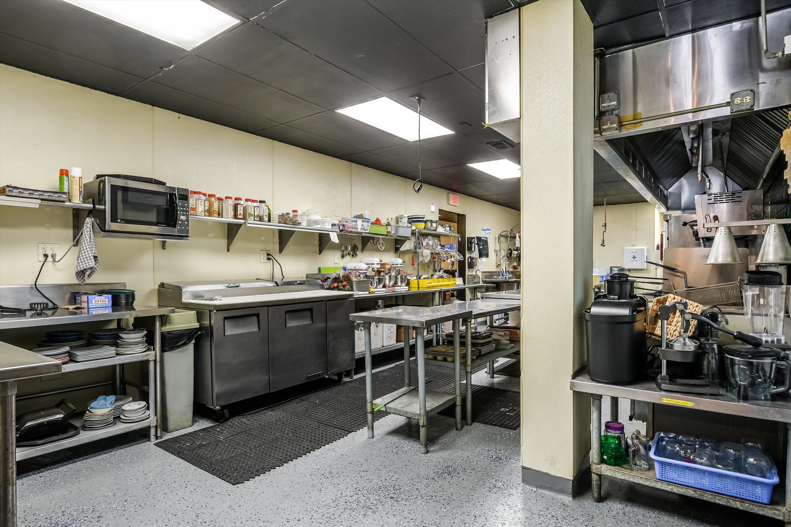 5481 North Northwest Highway Chicago, IL 60630 - Photo 13 of 60 a kitchen with stainless steel appliances kitchen island granite countertop a stove a sink and a microwave