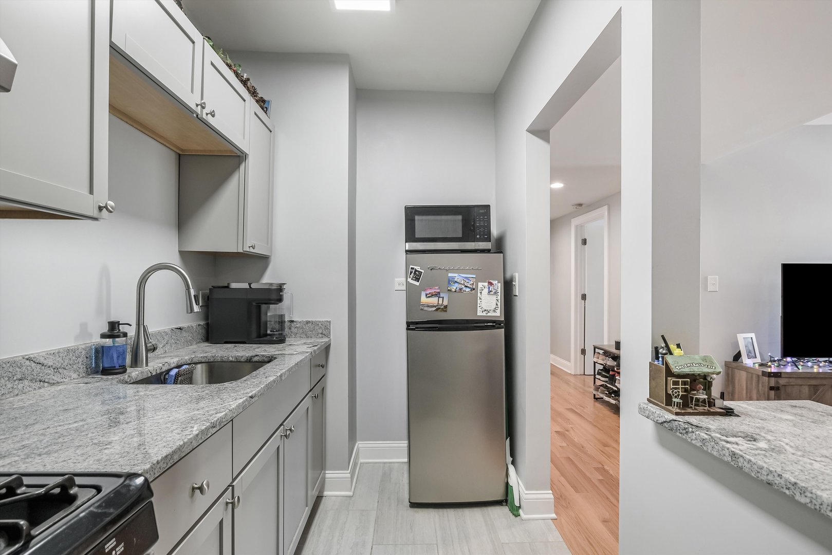 5481 North Northwest Highway Chicago, IL 60630 - Photo 22 of 60 a kitchen with granite countertop a refrigerator and a sink