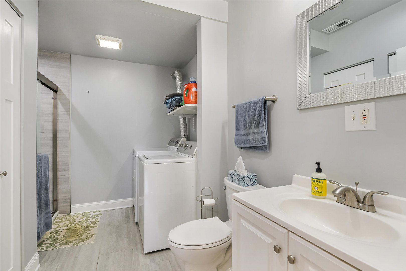 5481 North Northwest Highway Chicago, IL 60630 - Photo 26 of 60 a bathroom with a sink a toilet and a mirror
