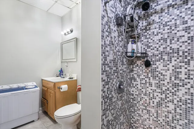 a view of kitchen with kitchen island microwave and wooden floor