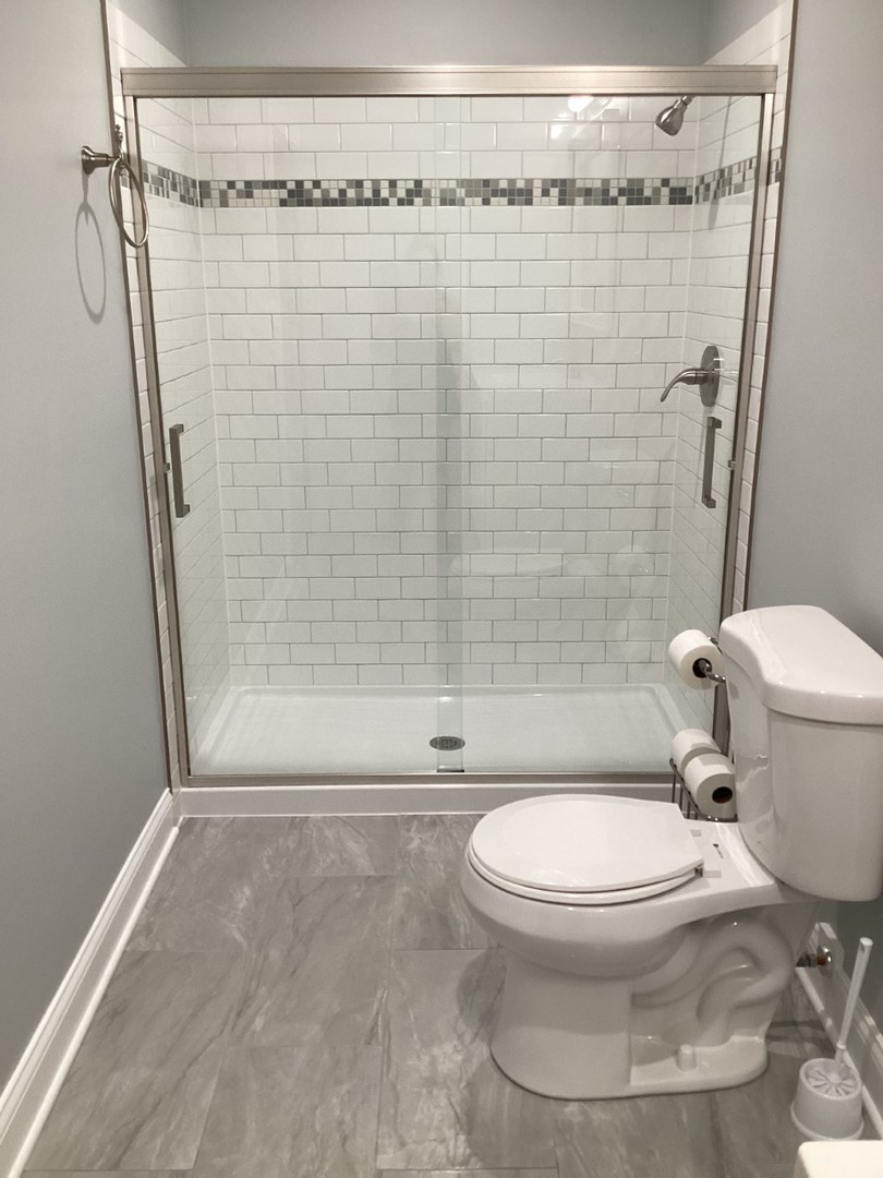 5481 North Northwest Highway Chicago, IL 60630 - Photo 41 of 60 a bathroom with a toilet and shower