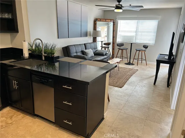 a kitchen with stainless steel appliances granite countertop a sink a stove and a microwave