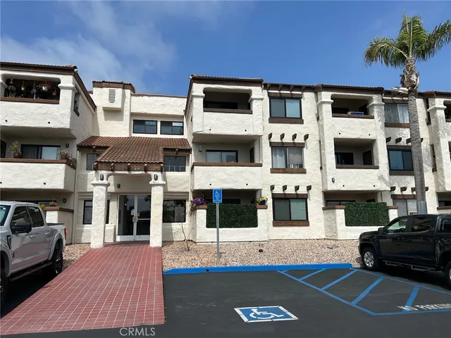 a view of a building with car parked