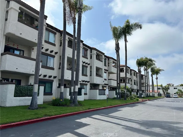 a view of a tall building next to a yard