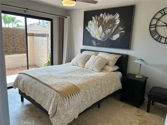 a bedroom with a bed and painting on the wall