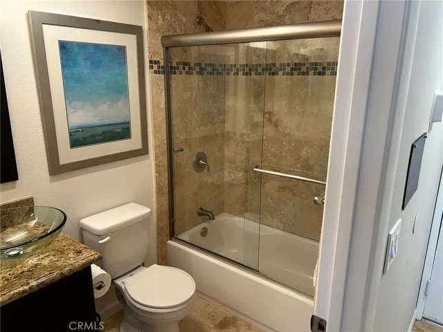 a white toilet sitting next to a bathroom sink