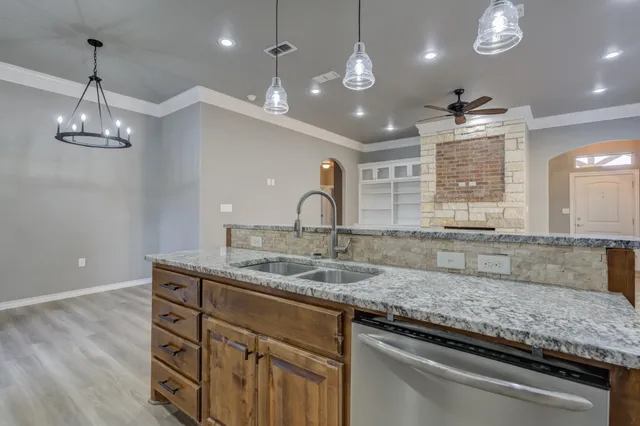 a kitchen with a sink and chandelier
