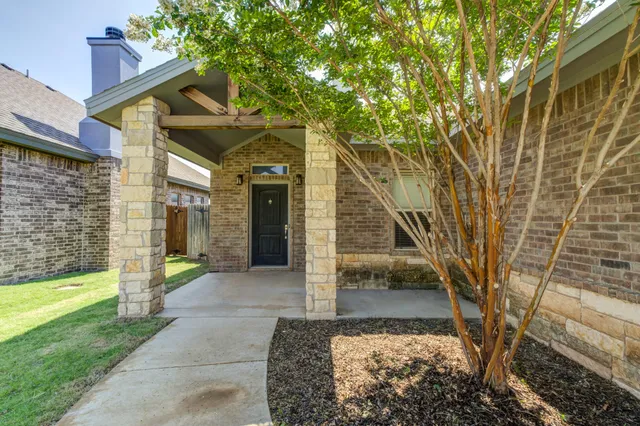 a view of a pathway of a house with a yard