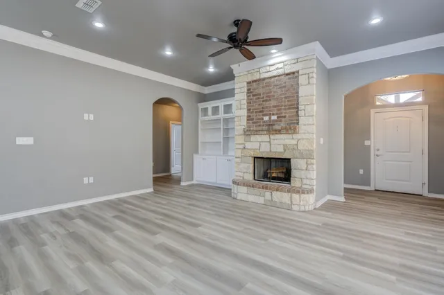 wooden floor in an empty room with a fireplace