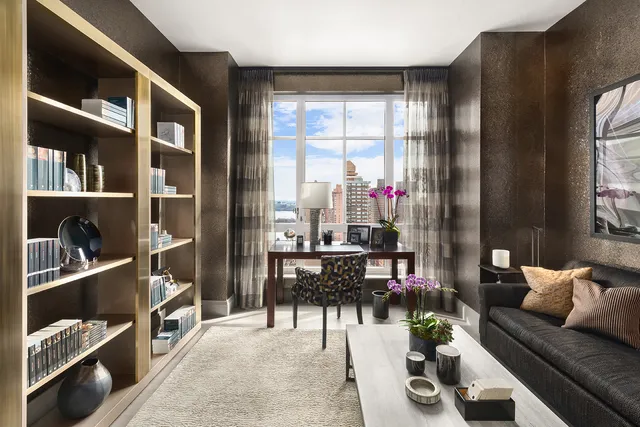 a living room with furniture and flat screen tv