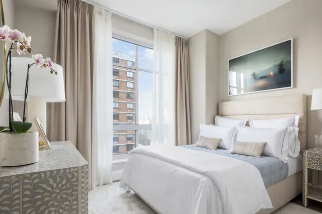 a bathroom with a double vanity sink a mirror and a bathtub