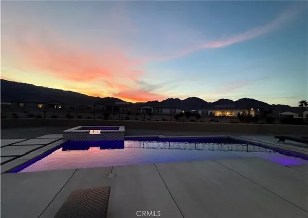 a view of swimming pool with mountain view in back