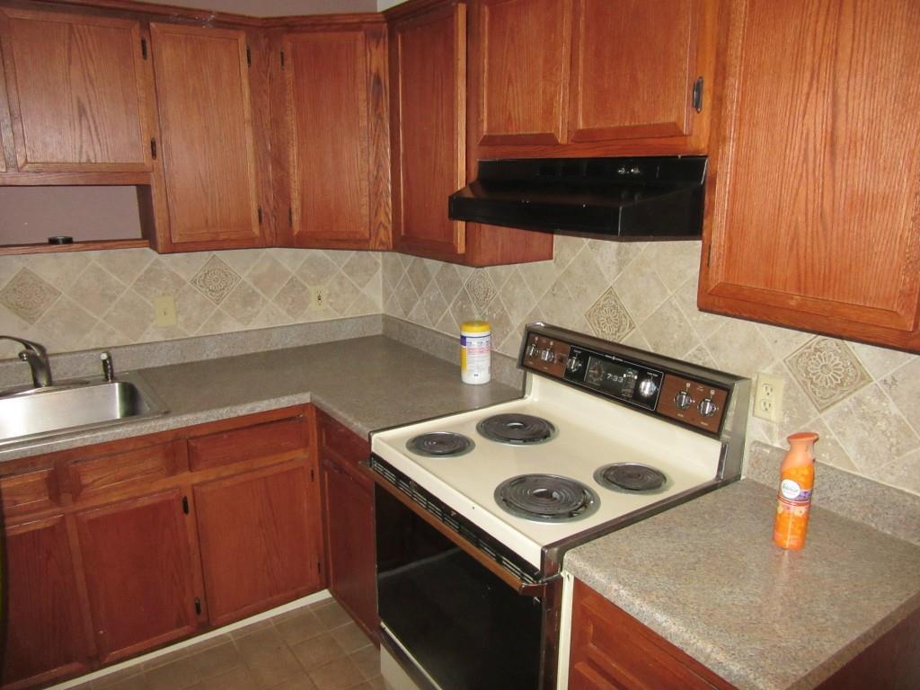 80 Buddington Road, Unit 8 Groton, CT 06340 - Photo 1 of 1 a kitchen with a sink a stove and cabinets
