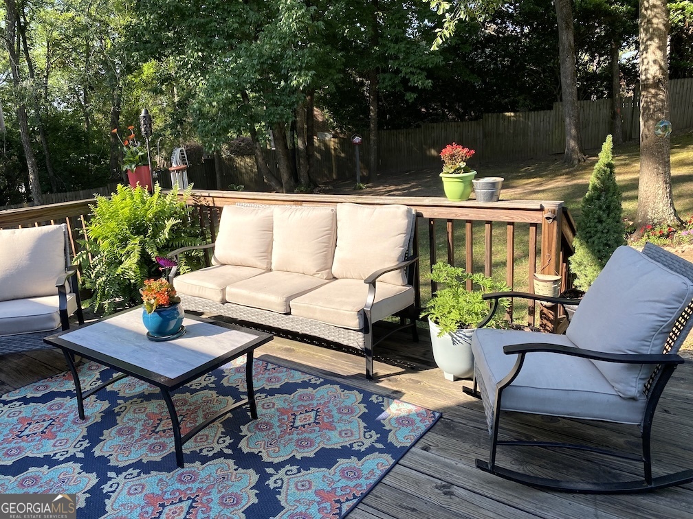101 Cords Bridge Road Northeast Milledgeville, GA 31061 - Photo 17 of 44 a roof deck with a table and chairs and potted plants