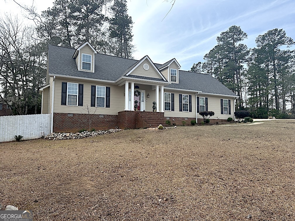 101 Cords Bridge Road Northeast Milledgeville, GA 31061 - Photo 2 of 44 a front view of a house with a yard and garage