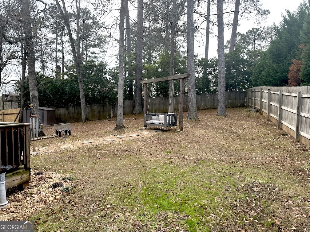 101 Cords Bridge Road Northeast Milledgeville, GA 31061 - Photo 24 of 44 a view of outdoor space with deck and trees