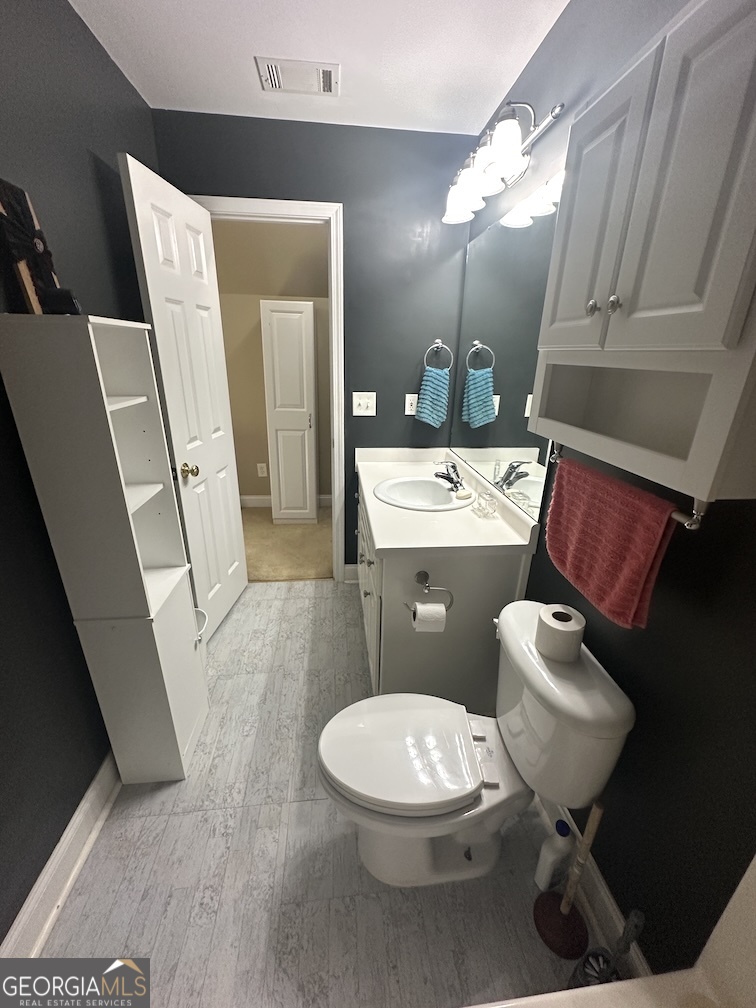 101 Cords Bridge Road Northeast Milledgeville, GA 31061 - Photo 35 of 44 a bathroom with a toilet sink and mirror
