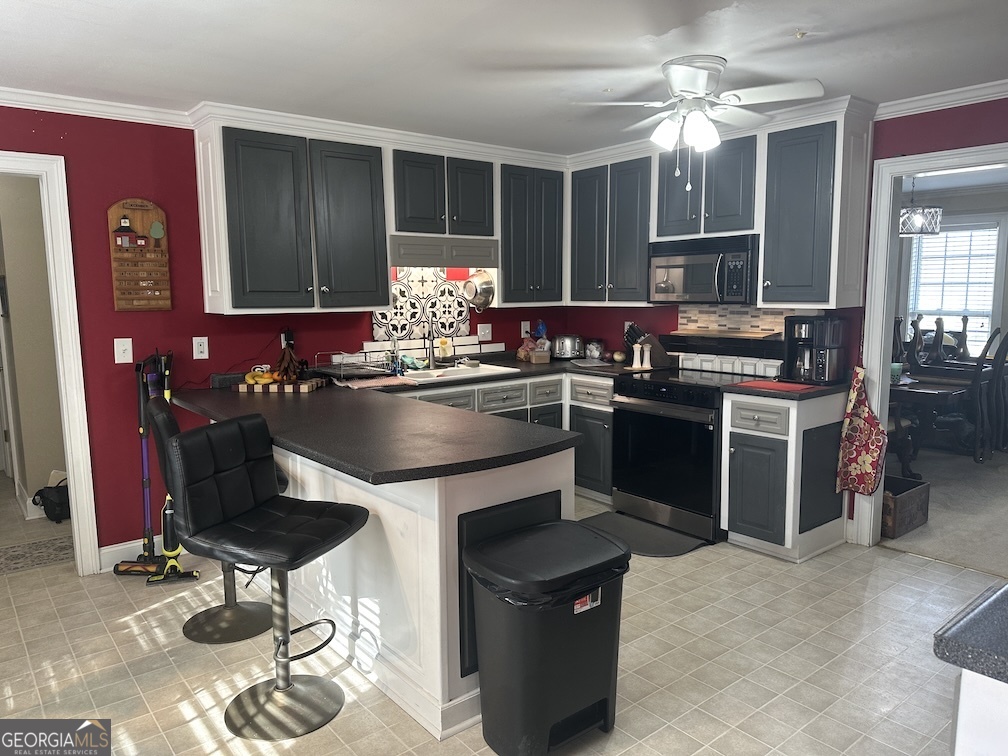 101 Cords Bridge Road Northeast Milledgeville, GA 31061 - Photo 37 of 44 a kitchen with stainless steel appliances granite countertop a stove top oven a dining table and chairs