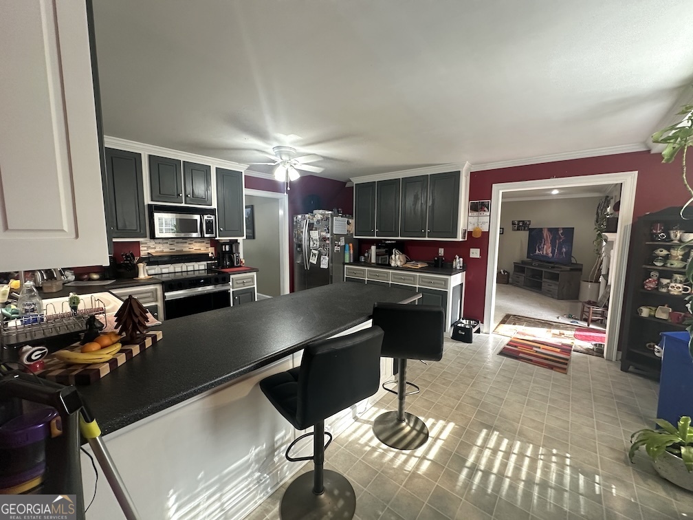 101 Cords Bridge Road Northeast Milledgeville, GA 31061 - Photo 41 of 44 a kitchen with granite countertop a stove and a refrigerator