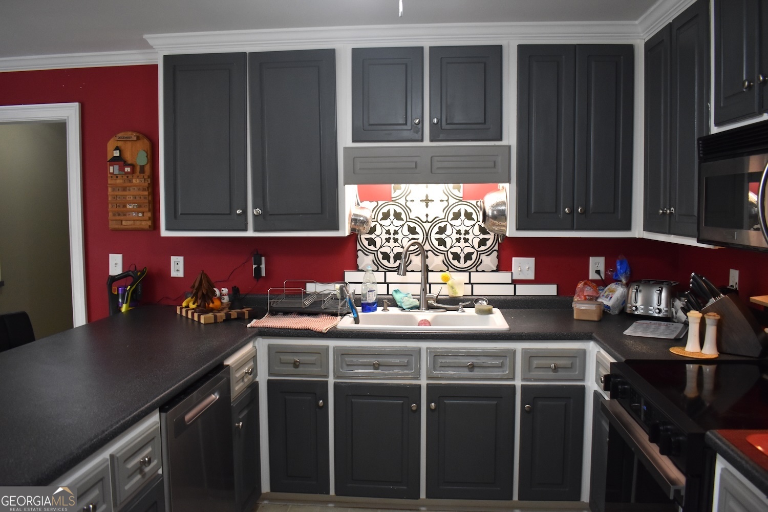 101 Cords Bridge Road Northeast Milledgeville, GA 31061 - Photo 43 of 44 a kitchen with a sink stove and cabinets