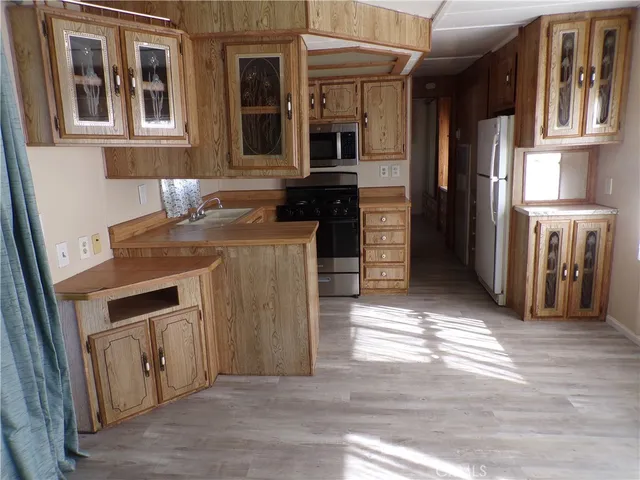 a kitchen with a sink and a refrigerator
