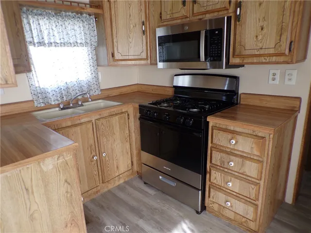 a kitchen with stainless steel appliances granite countertop a stove and a microwave