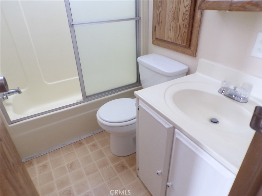 12710 3rd Street, Unit 10 Yucaipa, CA 92399 - Photo 6 of 9 a white toilet sitting next to a bathroom sink