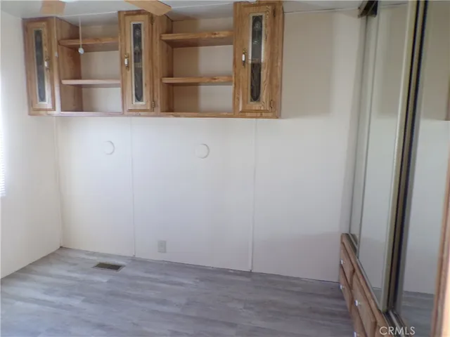 a view of a room with wooden floor