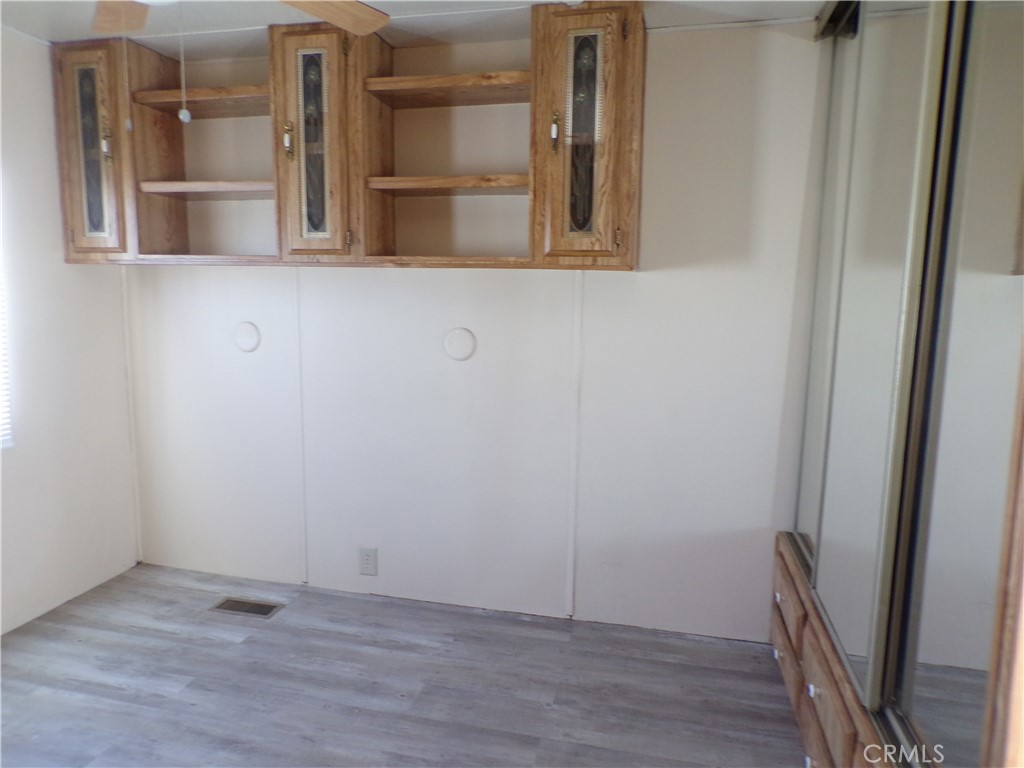 12710 3rd Street, Unit 10 Yucaipa, CA 92399 - Photo 7 of 9 a view of a room with wooden floor