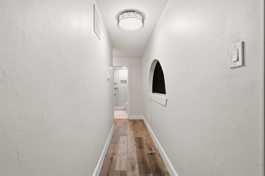 7354 Walling Lane Dallas, TX 75231 - Photo 12 of 28 a view of a hallway with wooden floor