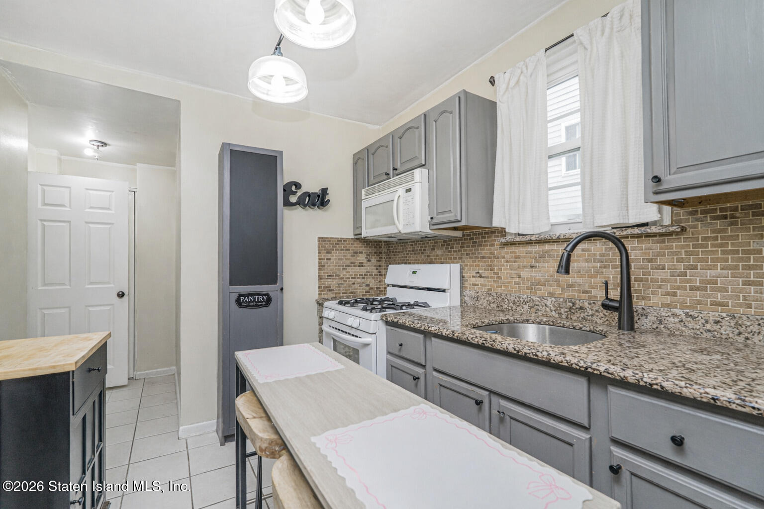 39 Post Lane Staten Island, NY 10303 - Photo 5 of 17 a kitchen with stainless steel appliances granite countertop a sink stove and refrigerator