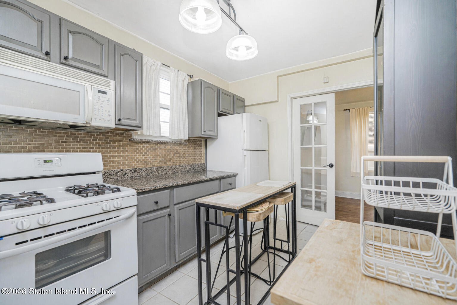 39 Post Lane Staten Island, NY 10303 - Photo 6 of 17 a kitchen with stainless steel appliances granite countertop a stove a sink and a refrigerator