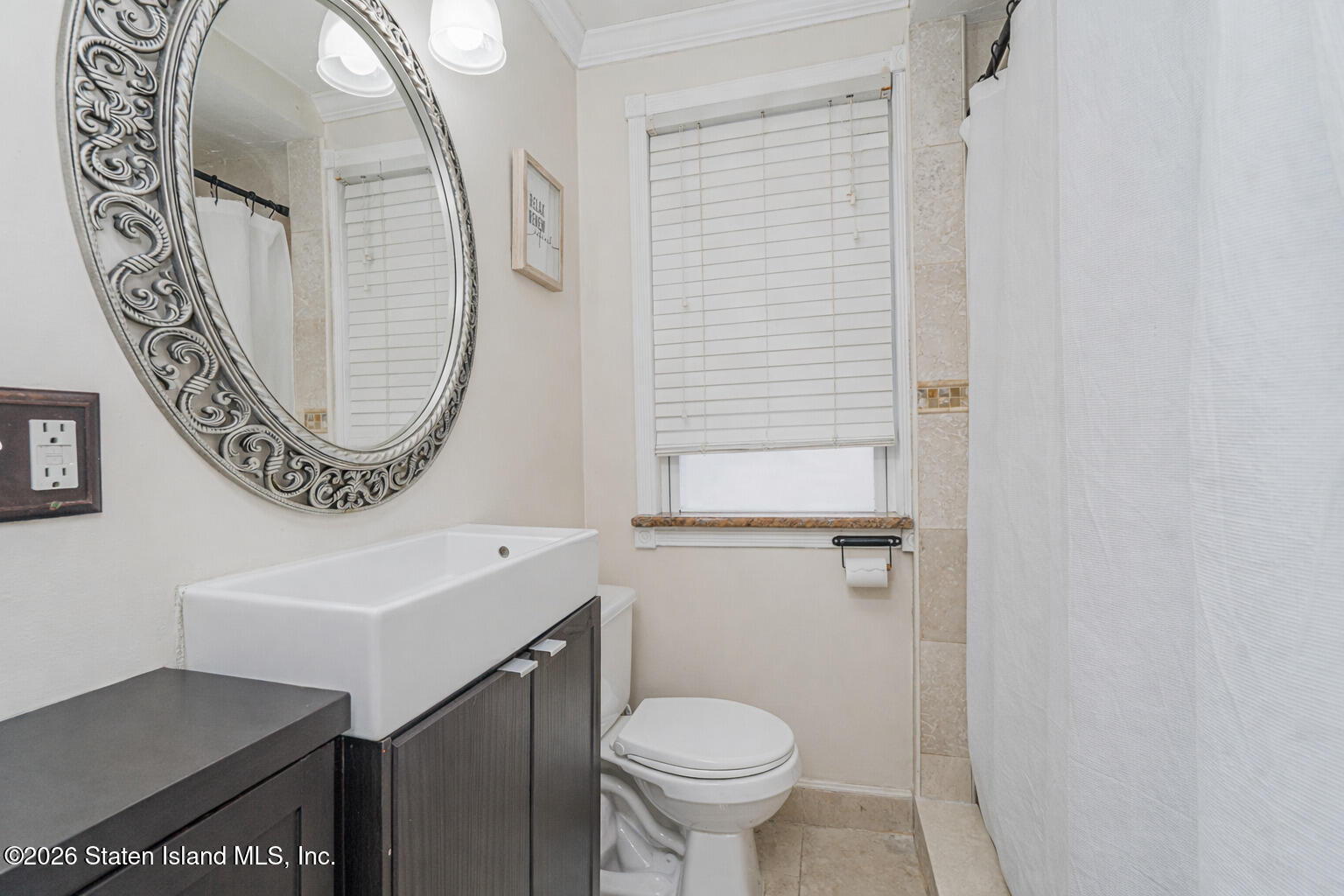 39 Post Lane Staten Island, NY 10303 - Photo 7 of 17 a bathroom with a toilet sink and mirror
