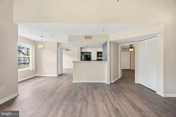 a view of a kitchen with wooden floor and a kitchen