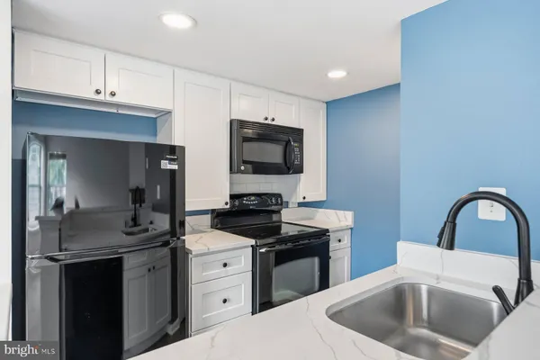 a kitchen with a sink stove and refrigerator