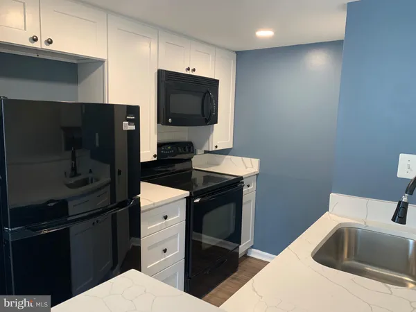 a kitchen with a refrigerator sink and stove