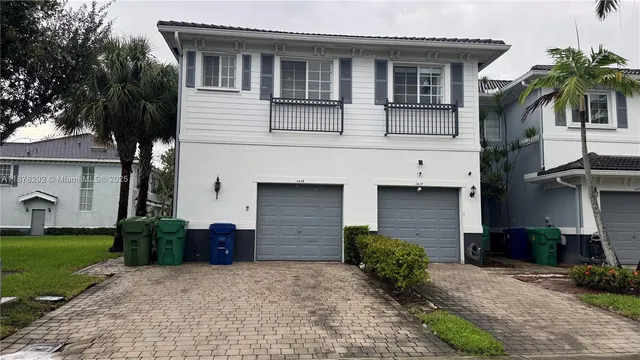 a front view of a house with a yard and a garage