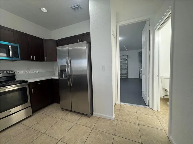 a kitchen with a refrigerator and a sink