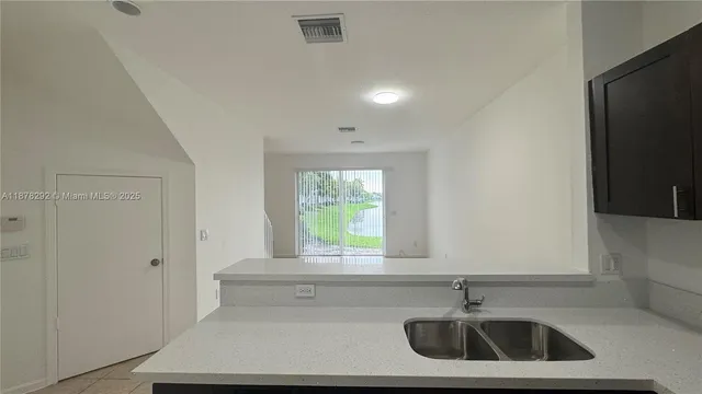 a bathroom with a sink and a window