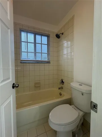 a bathroom with a toilet a sink and bathtub