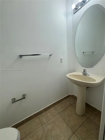 a bathroom with a sink toilet and mirror